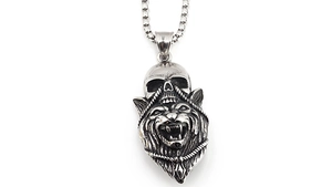 Macro detail of gothic wolf and skull pendant with vintage silver oxidized finish