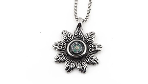 Macro shot of a functional compass pendant with flame petals on a box chain
