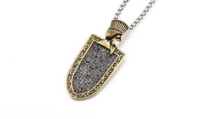 Detailed macro view of retro Pharaoh shield pendant with black crystals and box chain