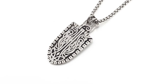 Detail of vintage shield pendant with Celtic knot etchings and sturdy box chain