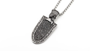 Detailed close-up of Pharaoh relief pendant with pave black zircons on a silver box chain