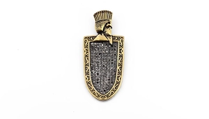 Macro shot of hip hop pharaoh pendant with black rhinestones and golden engraved detail