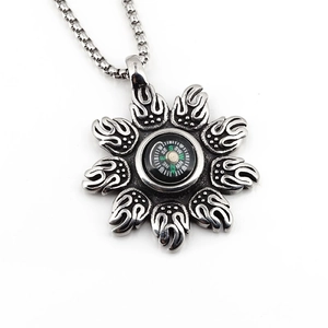 Vintage sunburst compass pendant necklace in oxidized steel with a functional mini compass