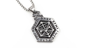 Detail of vintage Nordic Viking pendant with runic alphabet and geometric hexagram symbols