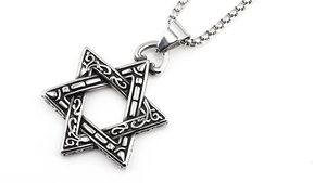 Macro shot of retro hexagram pendant with vine textures on a sturdy silver box chain