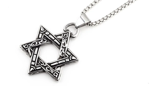 Detail of vintage hexagram pendant with intricate geometric texture on a steel chain