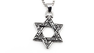 Detailed macro view of silver steel Star of David pendant with vintage floral patterns