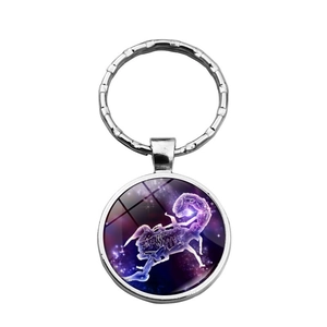 Detailed view of Scorpio zodiac sign glass dome keychain with purple starry sky pattern