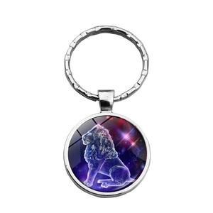 Silver metal keychain with Leo zodiac star constellation under round glass gemstone