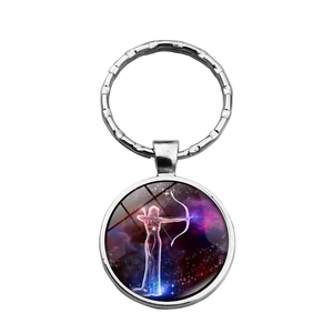 Silver Sagittarius zodiac glass dome keychain featuring cosmic nebula illustration
