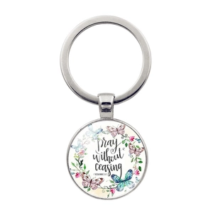 Silver metal keychain with floral butterfly wreath and 'Pray without ceasing' quote