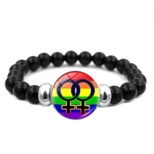 Detailed close-up of a black beaded Pride bracelet featuring a rainbow female symbol charm