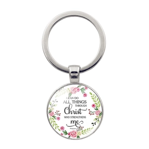 Detail of floral round metal keychain featuring Bible verse Philippians 4:13 engraving