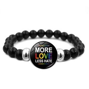 Detail of black beaded bracelet with More Love Less Hate rainbow slogan and silver accents