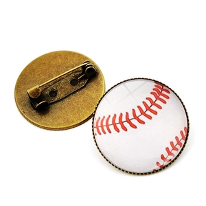 Macro shot of baseball glass brooch showing vintage bronze back and pin closure