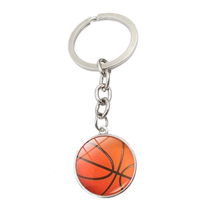 Makroaufnahme vom Basketball-Schlüsselanhänger aus Silbermetall mit rundem Glasanhänger