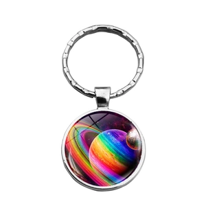 Detail of galaxy nebula glass cabochon keychain featuring vibrant Saturn and space imagery