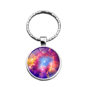 Detailed close-up of a round galaxy nebula art pendant keychain with silver metal alloy ring