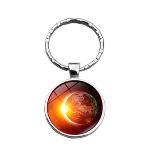 Detailed view of galaxy nebula glass dome pendant on a silver metal keychain ring