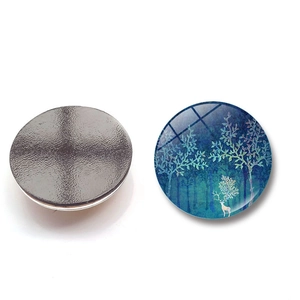Detail view of round 3cm crystal glass fridge magnet with forest elk and magnetic back