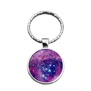 Round galaxy nebula keychain with purple stellar pattern in silver metal ring setting