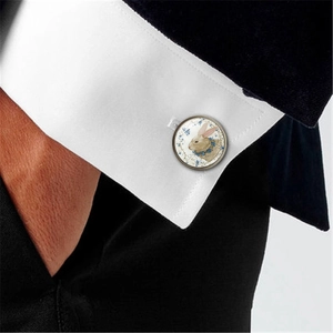 Vintage style round Easter bunny cufflinks with blue flowers on a white shirt sleeve