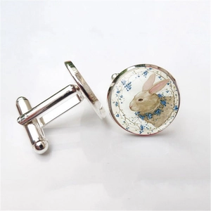 Detailed view of silver rabbit cufflinks with blue floral glass dome for French shirts