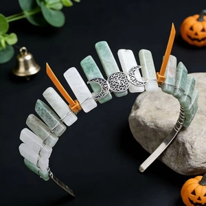 Detail of handmade crystal crown with moon symbol and orange horns for Halloween