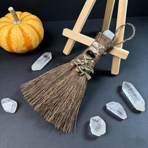Mini Wicca witch broom with crystal point, obsidian, and metal charm on wooden display