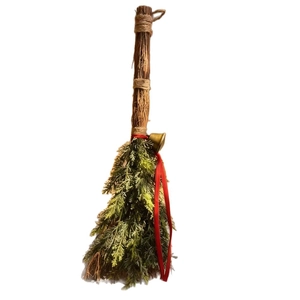 Handmade Christmas broom with pine needles, red ribbon and golden bell decoration