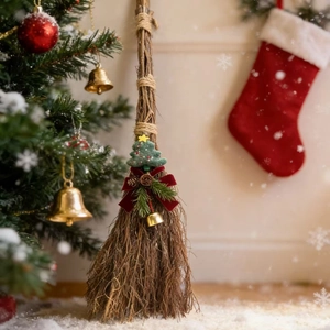 Natural wood Christmas decorative broom with miniature tree and red velvet bow on snow