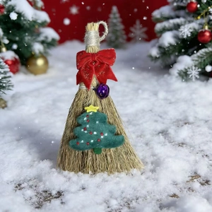 Festive Christmas broom with red bow and green tree decoration on snow background