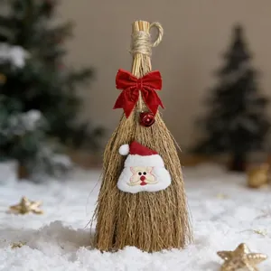 Festive handmade straw Christmas broom with red velvet bow and Santa felt patch on snow
