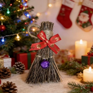 Handmade Christmas decorative broom with red ribbon bow and bell in warm festive setting