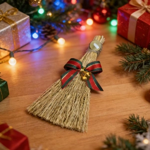 Miniature natural straw Christmas broom decoration with festive red bow and gold bell