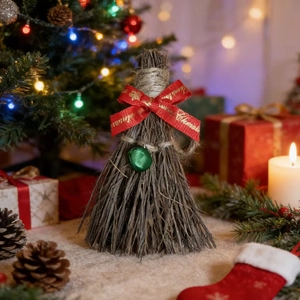 Detail of Christmas broom ornament with red Merry Christmas ribbon and green bell