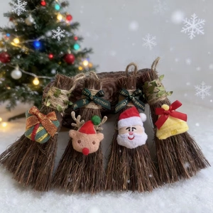 Set of four Christmas mini broom ornaments with festive reindeer and Santa designs