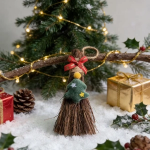 Macro view of Christmas mini broom ornament with red ribbon and felt tree detail