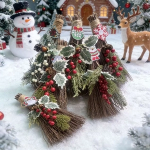 Macro detail of handmade Christmas mini brooms with pine needles and festive red berries