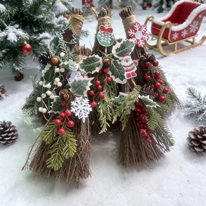 Handmade Christmas decorative broom with pine cones and red berries on snow background