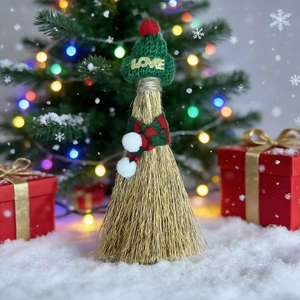 Detailed view of Christmas mini broom with green knitted LOVE hat and festive scarf