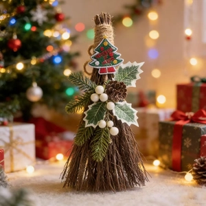 Christmas broom ornament with pine cones and embroidery in a festive warm setting