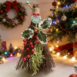 Detail of Christmas broom ornament with red berries, holly leaves and festive bow tie
