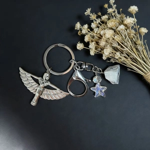 Silver metal keychain with Isis goddess pendant, colorful star bead, and natural crystal stone