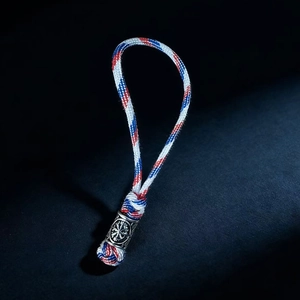 Detail showing red white and blue paracord weave with viking style metal bead