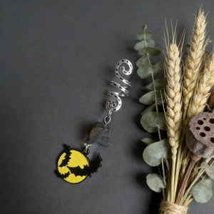 Detail of Halloween hair coil with silver spiral, crystal stone, and enamel bat charm