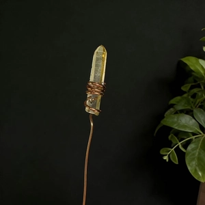Macro detail of raw citrine crystal wrapped in copper wire for floral arrangement