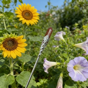 Detailed view of handmade silver floral filigree hair pin with gold sandstone crystal