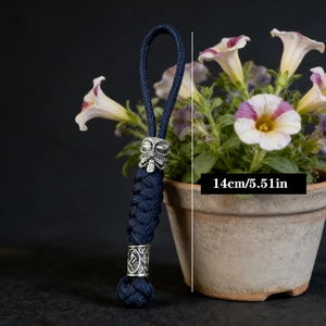 Handmade navy blue paracord keychain with silver Viking beads and mask charm, 14cm long