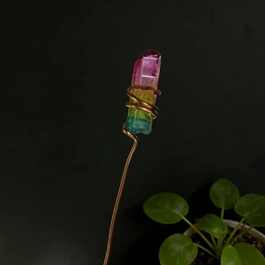 Detailed shot of handmade rainbow crystal wrapped in copper wire for floral decoration
